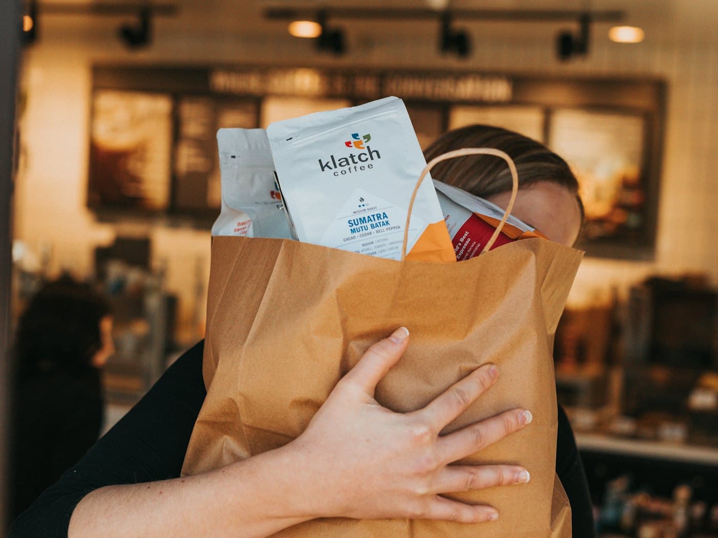 Une cliente repart avec son sac d’achats récupéré en boutique